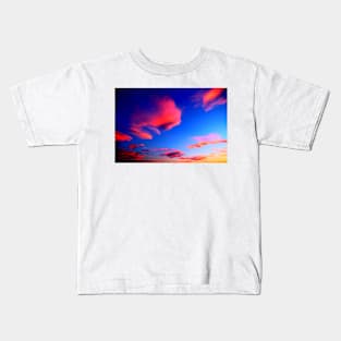 Plenty of bright pink clouds scattered on the yellow-blue sky Kids T-Shirt